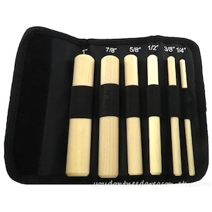 May include: Set of six wooden dowels in a black zippered pouch. The dowels are labeled with their diameter in inches: 1", 7/8", 5/8", 1/2", 3/8", and 1/4".