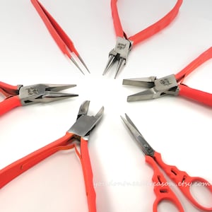 May include: A set of six orange-handled jewelry making tools, including round nose pliers, flat nose pliers, chain nose pliers, flush cutters, tweezers, and a pair of scissors.