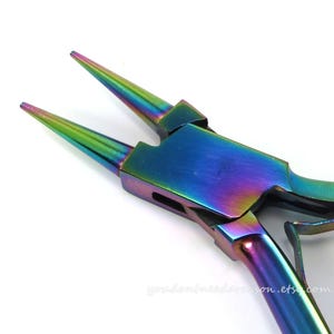 May include: Rainbow colored pliers with a pointed tip, used for jewelry making.
