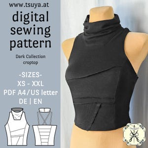 Op de afbeelding: Een zwarte mouwloze croptop met een opstaande kraag en een gelaagd paneelontwerp aan de voorzijde. De afbeelding bevat de tekst: www.tsuya.at digital sewing pattern Dark Collection croptop -SIZES- XS - XXL PDF A4/US letter DE | EN en een technische lijntekening.