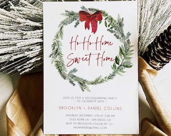 May include: A housewarming party invitation with a watercolor wreath design. The invitation features the text "Ho Ho Home Sweet Home" in red script, with event details below. The invitation is surrounded by frosted greenery and a pine cone.