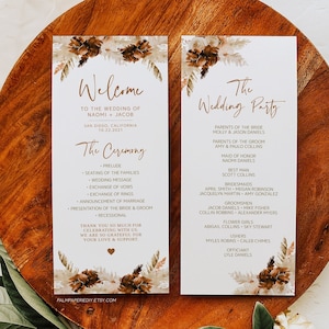 May include: Two wedding ceremony programs with floral accents, featuring the words "Welcome" and "The Wedding Party." The programs are on a wooden surface with greenery and a dried flower.