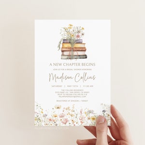 May include: A white bridal shower invitation with a watercolor illustration of a stack of books with flowers on top. The text reads "A New Chapter Begins" and "Join us for a bridal shower honoring Madison Collins".