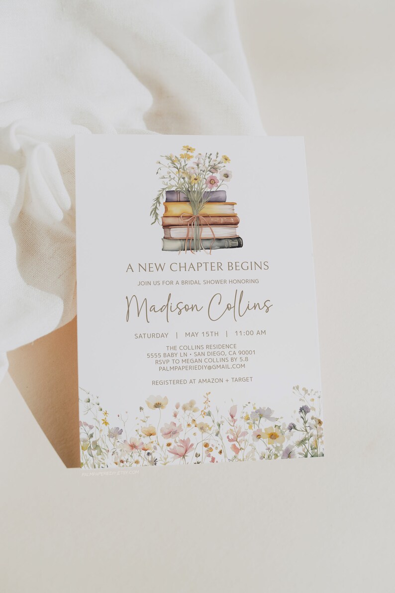 May include: A white card with a floral design and a stack of books with a bouquet of flowers on top. The text on the card reads "A New Chapter Begins" and "Join us for a bridal shower honoring Madison Collins". The date and time of the shower are listed as "Saturday, May 15th, 11:00 AM". The location is listed as "The Collins Residence, 5555 Baby Ln, San Diego, CA 90001". The RSVP information is "RSVP to Megan Collins by 5.8, Palmpaperiediy@gmail.com". The registry information is "Registered at Amazon + Target".