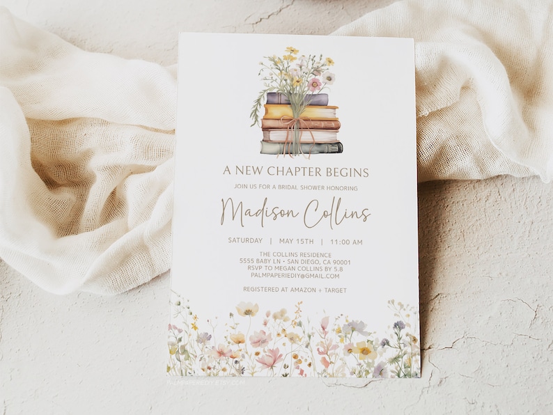 May include: A white card with a floral design at the bottom and a stack of books with a bouquet of flowers on top. The text on the card reads "A New Chapter Begins" and "Join us for a bridal shower honoring Madison Collins". The date and time of the event are listed as "Saturday, May 15th, 11:00 AM". The location is listed as "The Collins Residence, 5555 Baby Ln, San Diego, CA 90001". The RSVP information is listed as "RSVP to Megan Collins by 5.8, palmpaperiediy@gmail.com". The registry information is listed as "Registered at Amazon + Target".