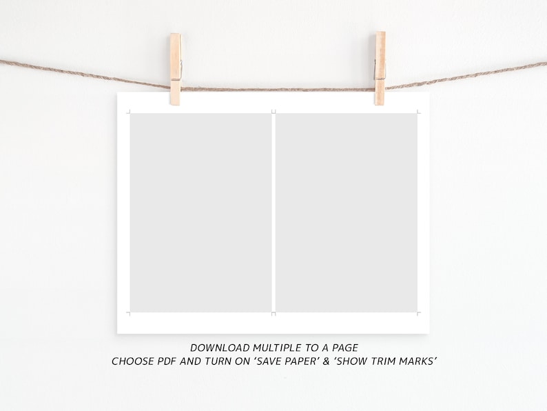 May include: A white sheet of paper with a vertical line down the center, hanging from a string with wooden clothespins. The text below the paper reads "DOWNLOAD MULTIPLE TO A PAGE CHOOSE PDF AND TURN ON 'SAVE PAPER' & 'SHOW TRIM MARKS'".