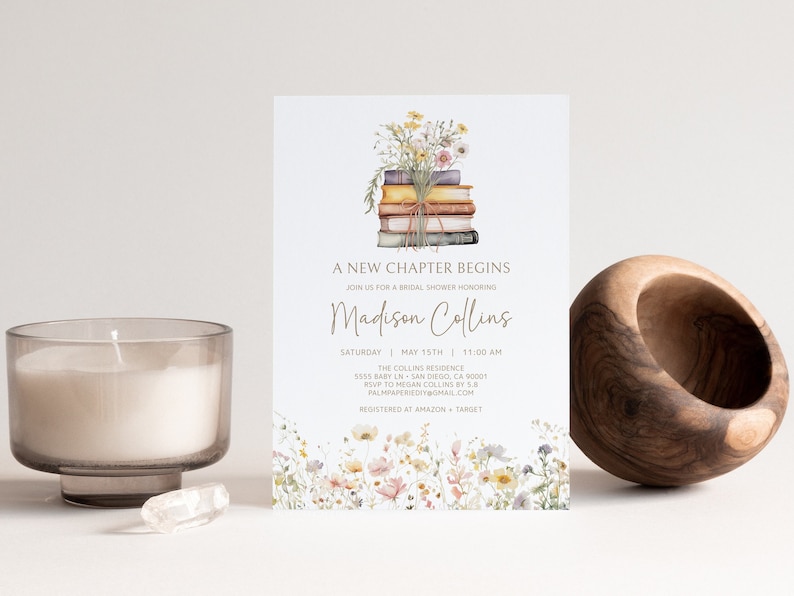 May include: A bridal shower invitation with a watercolor illustration of a stack of books with flowers on top. The text reads "A New Chapter Begins" and "Madison Collins".