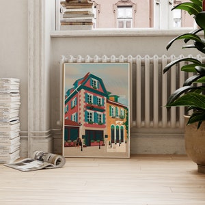 Art print depicting the colourful buildings of Alsace, France, adorned with flowers on a cobble stone street.