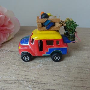 Small hand painted plaster bus, Ecuadorian bus with passengers, fruits and goods, handmade souvenir bus
