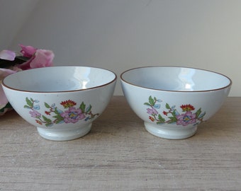 Two speckled beige ceramic breakfast bowls with a decoration of pink and orange flowers, small retro boho kitchen tableware