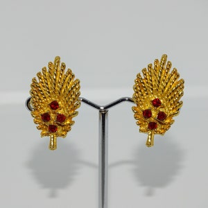 Vintage costume jewellery gold tone metal clip on earrings with beautiful red rhinestones and feathered detail
