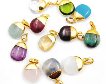 May include: Assortment of 10 gemstone pendants with gold accents. The pendants feature various colors and patterns, including clear, green, blue, aquamarine, purple, pink, and brown.