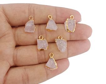 May include: Seven gold-plated rose quartz charms with irregular shapes. The charms have a raw, natural look and are perfect for jewellery making.