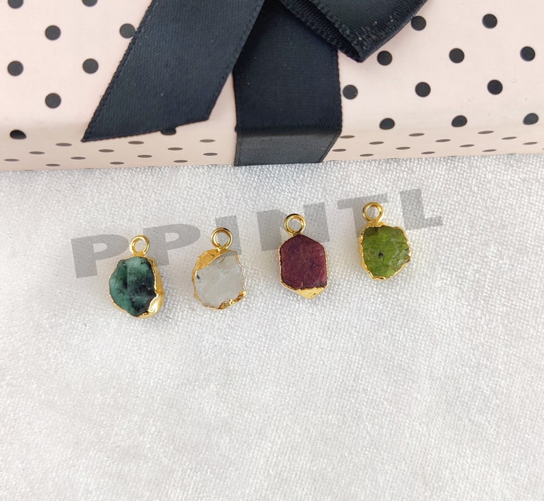 May include: A white ceramic mug with a black handle and the text "But First, Coffee" in a bold, black font. The mug is set against a blurred background, suggesting a cozy setting.