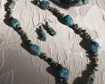 May include: A turquoise and brown stone necklace, bracelet, and earrings set. The necklace and bracelet feature large, irregular turquoise stones, while the earrings are smaller and more delicate.