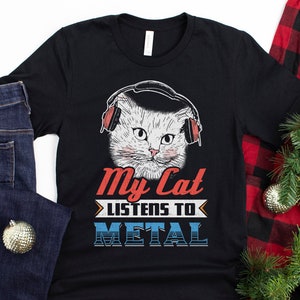 May include: A black t-shirt with a white cat wearing headphones and the text "My Cat Listens To Metal".