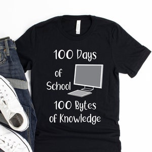 May include: Black t-shirt with white text that reads "100 Days of School 100 Bytes of Knowledge". A computer monitor and keyboard are illustrated on the shirt.