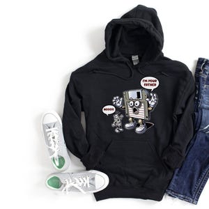 May include: Black hooded sweatshirt with a cartoon floppy disk character saying "I'M YOUR FATHER" and a smaller robot character saying "NOOOO!!". The image also includes a pair of blue jeans and gray sneakers.