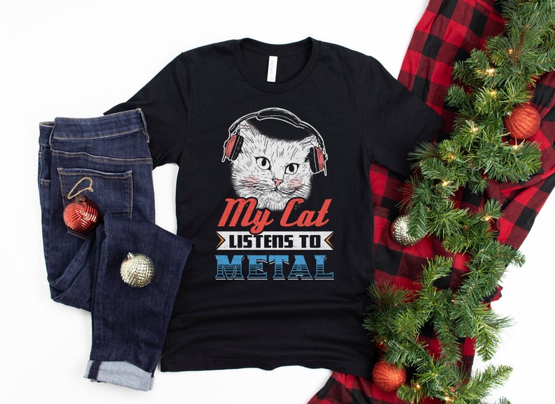 May include: A black t-shirt with a white cat wearing headphones and the text "My Cat Listens To Metal".