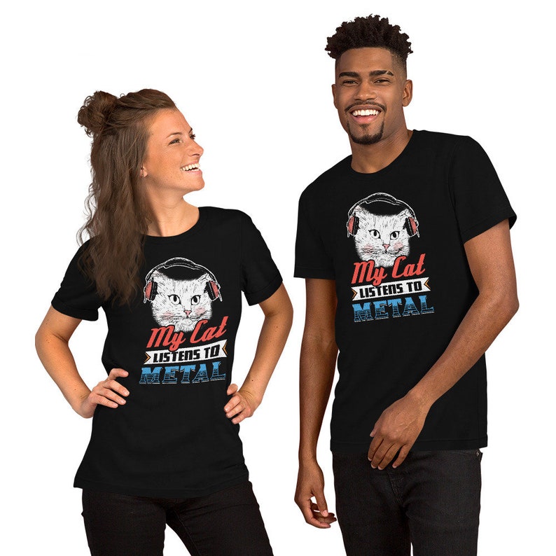 May include: Two people wearing black t-shirts with a white cat wearing headphones and the text "My Cat Listens To Metal".