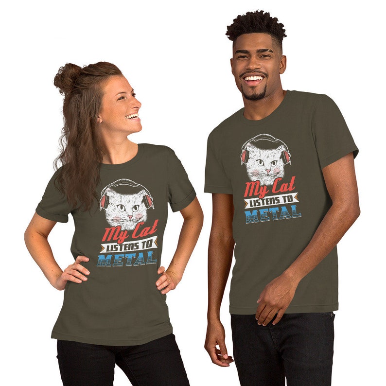 May include: Two people wearing olive green t-shirts with a white cat wearing headphones and the text "My Cat Listens To Metal".