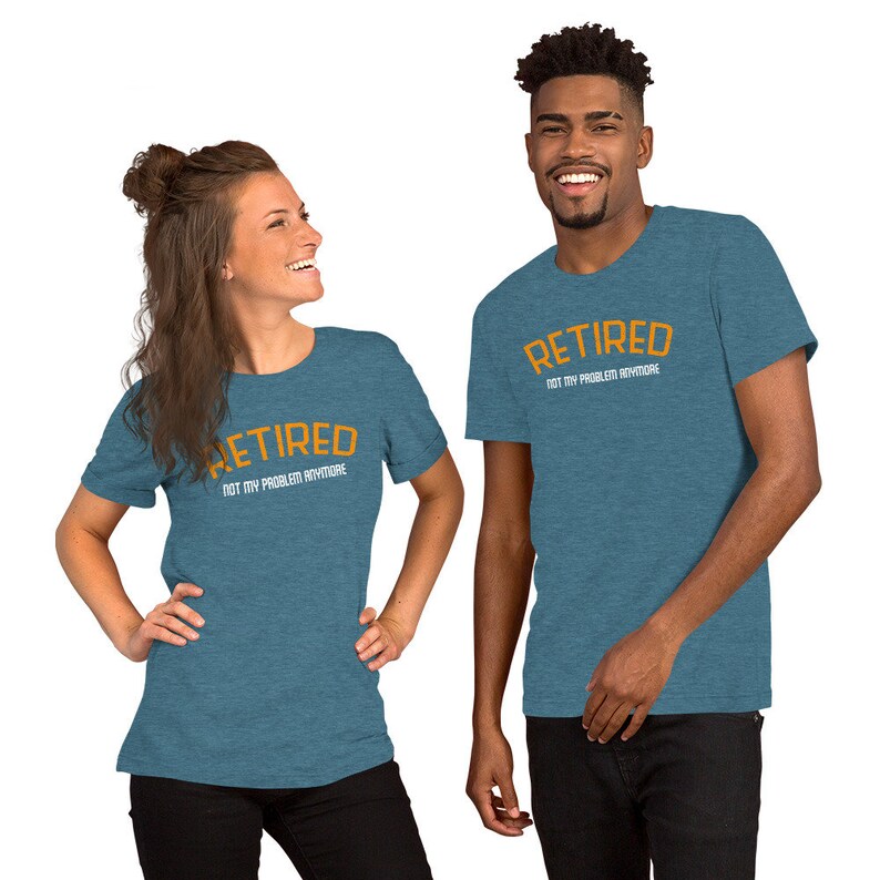 May include: Two people wearing teal blue t-shirts with the text "Retired Not My Problem Anymore" in orange and white lettering.