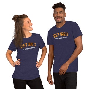 May include: Two people wearing navy blue t-shirts with the text "Retired Not My Problem Anymore" in orange. The text is in an arched shape.