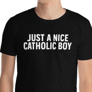 May include: Black t-shirt with white text that reads "JUST A NICE CATHOLIC BOY".