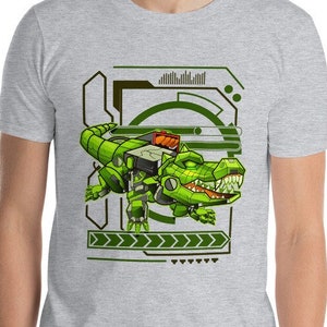 May include: A grey t-shirt featuring a green, robotic alligator design. The alligator is set against a futuristic, tech-inspired backdrop with green and black geometric shapes.