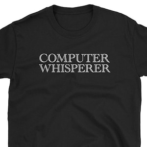 May include: Black t-shirt with white text that reads "COMPUTER WHISPERER".