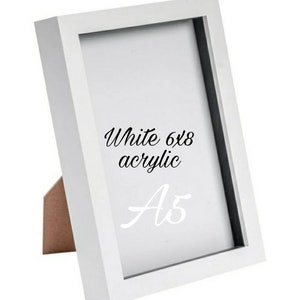 May include: White 6x8 acrylic picture frame with a black mat and a white stand. The frame is labeled "A5".