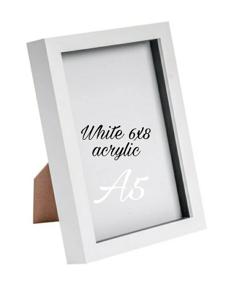 May include: White 6x8 acrylic picture frame with a black mat and a white stand. The frame is labeled "A5".