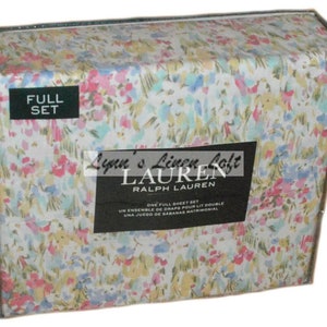 May include: A full sheet set in a box with a floral pattern. The bedding set features a white background with a colorful floral design in pink, blue, and yellow. The box has the text "Lynn's Linen Loft" and "Ralph Lauren".