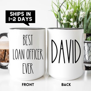 May include: White ceramic coffee mug with a black rim. The front of the mug reads "Best Loan Officer Ever". The back of the mug reads "David".