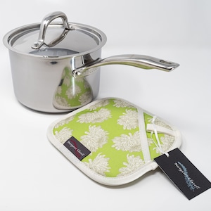 May include: A stainless steel saucepan with a lid and a green and white floral pot holder with a white tag that says "Margaret Clavell".