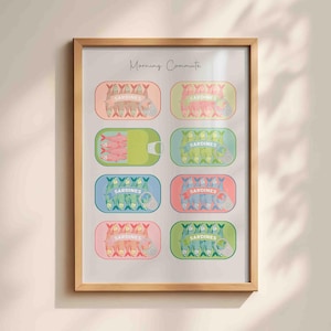 May include: A framed art print with illustrations of sardine tins in various colours. Each tin shows sardines and the word "Sardines". The text "Morning Commute" is at the top of the print.