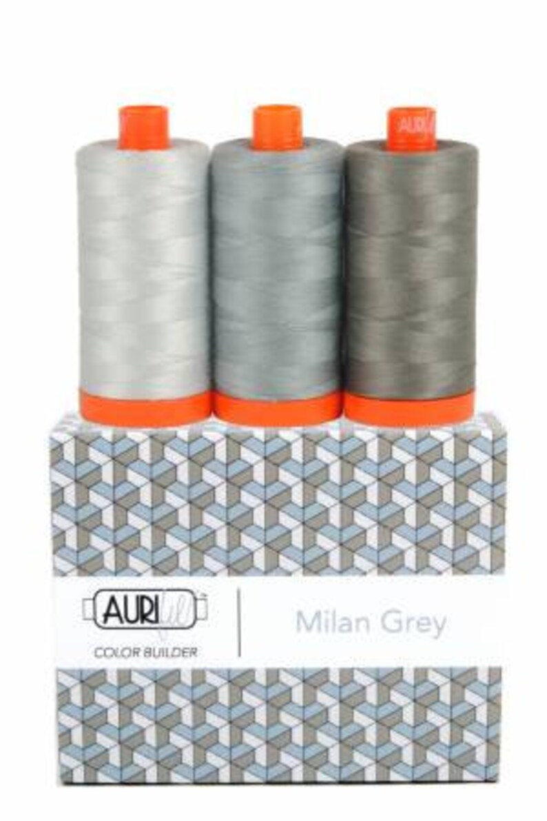 May include: Three spools of thread in shades of gray, labeled "Milan Grey" and "AURI Color Builder".