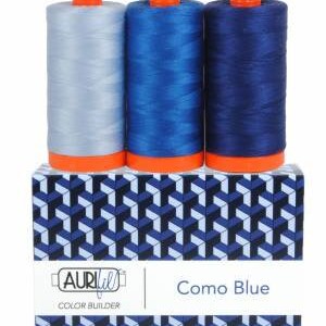 May include: Three spools of thread in shades of blue, labeled "Como Blue" and "Aurifil Color Builder".