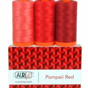 May include: Three spools of red thread in different shades of red, labeled "Pompeii Red" and "Aurifil Color Builder".