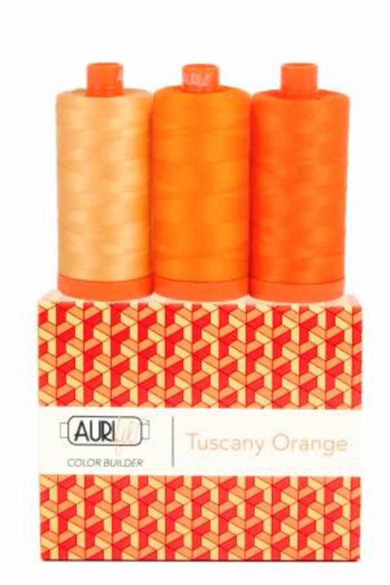 May include: Three spools of Aurifil thread in shades of orange, labeled "Tuscany Orange" and "Color Builder".