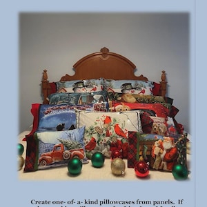 May include: A booklet titled Pillowcases from Panels Christmas Book JMD-216 featuring instructions for sewing pillowcases. The cover displays a bed with multiple decorative pillowcases showing Christmas scenes like snowmen, Santa, and cardinals.