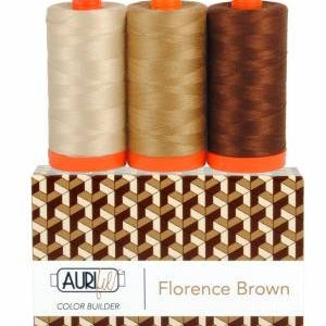 May include: Three spools of thread in beige, brown, and dark brown shades. The spools are labeled "Aurifil Color Builder Florence Brown".