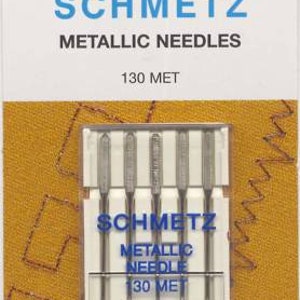 May include: A package of five silver metallic sewing needles for use in a sewing machine. The package is labeled "Schmetz Metallic Needles 130 Met 90/14".