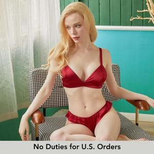 May include: A red satin lingerie set, comprising a triangle bra and ruffled shorts. The set is shown on a person seated in a chair with a black and white pattern. The text "No Duties for U.S. Orders" is at the bottom.