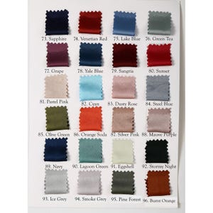 May include: A color chart featuring fabric swatches in various shades. The swatches are arranged in rows and columns, with each swatch labeled with a number and color name, including Sapphire, Venetian Red, and Lake Blue.