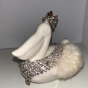 Assemblage of Fancy ceramic pelican with added fur, crown and jewels
