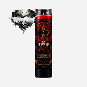 May include: A tall, black candle with a red top and a label that reads "LOVE ME OR LEAVE ME ALONE." The label features a woman, ornate designs, and the website witchesvalleystore.com. The candle is in a clear glass jar.
