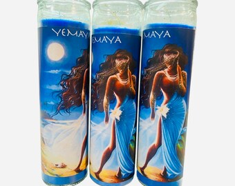 May include: Three glass candle jars with blue wax and a colourful image of a woman with long dark hair, wearing a blue dress and a white flower. The text "YEMAYA" is printed on the front of each jar.