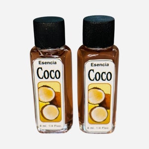 May include: Two small brown glass bottles with black caps, each containing a clear liquid. The bottles have white labels with the text "Esencia Coco" and a picture of a coconut. The labels also state "8 ml. 1/4 Floz."