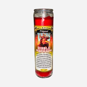May include: A red candle in a glass jar with a label featuring the text "VELADORA Original DIABLO MAMMON" and an illustration of a devil-like figure. The candle is cylindrical and filled with red wax.